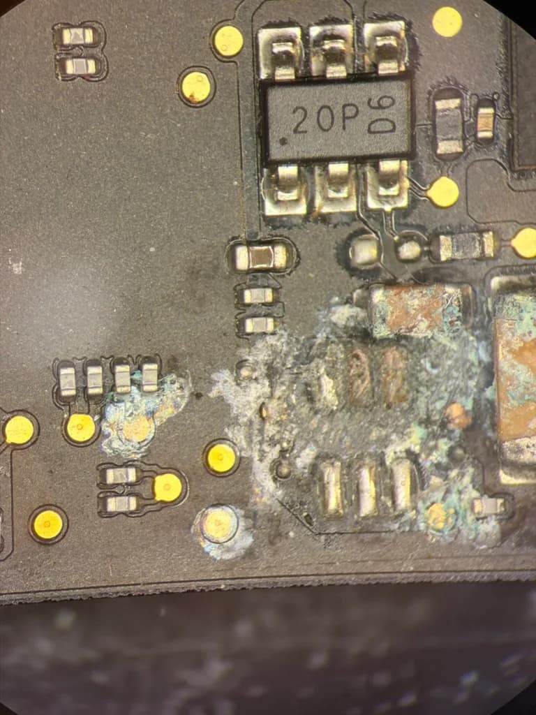 Microscope view of corrosion around small circuit board components